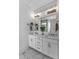 Bright bathroom vanity with double sinks, a large mirror, and decorative lighting fixtures at 112 Sire Ct, Holly Springs, NC 27540