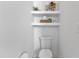 Clean half bathroom with a toilet and decorative wall shelves at 112 Sire Ct, Holly Springs, NC 27540