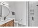 Modern bathroom with a vanity, round mirror, tile floors and a glass-door shower at 112 Sire Ct, Holly Springs, NC 27540