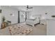 Cozy bedroom with neutral tones, a large bed, area rug, and a window with natural light at 112 Sire Ct, Holly Springs, NC 27540
