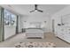 Serene bedroom featuring a large bed, window, ceiling fan, and neutral decor at 112 Sire Ct, Holly Springs, NC 27540