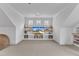 Bonus room featuring a ceiling fan, built in shelving, three windows, and a bean bag at 112 Sire Ct, Holly Springs, NC 27540