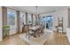 Dining room with large windows, wood floors, and access to an outdoor porch at 112 Sire Ct, Holly Springs, NC 27540