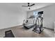 Well-lit exercise room with carpet, a ceiling fan, and various exercise machines at 112 Sire Ct, Holly Springs, NC 27540