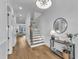Well-lit foyer showcasing hardwood floors and an elegant staircase at 112 Sire Ct, Holly Springs, NC 27540