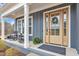 Charming front porch featuring classic rocking chairs and an elegant front door at 112 Sire Ct, Holly Springs, NC 27540
