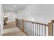 Bright upstairs hallway with wood railing and view to additional rooms at 112 Sire Ct, Holly Springs, NC 27540
