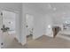 Bright hallway showcasing a guest bathroom, additional rooms, and custom railing at 112 Sire Ct, Holly Springs, NC 27540