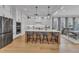 Modern kitchen featuring a large island, stainless steel appliances, and hardwood floors at 112 Sire Ct, Holly Springs, NC 27540