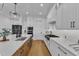 Bright kitchen boasts white cabinetry, stainless steel appliances, and a center island at 112 Sire Ct, Holly Springs, NC 27540