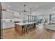 Spacious kitchen with a large center island, modern appliances, and open dining area at 112 Sire Ct, Holly Springs, NC 27540