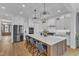 Elegant kitchen with a large center island, stainless steel appliances, and ample storage at 112 Sire Ct, Holly Springs, NC 27540