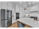 Modern kitchen boasts stainless steel appliances, white cabinetry, and large island at 112 Sire Ct, Holly Springs, NC 27540