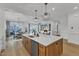 Open kitchen design with center island and view to the dining and living areas at 112 Sire Ct, Holly Springs, NC 27540