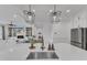 Spacious kitchen with a large island, stainless steel sink, and open floor plan at 112 Sire Ct, Holly Springs, NC 27540