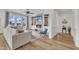 Open-concept living room featuring a cozy fireplace, built-ins, and comfortable seating with natural light at 112 Sire Ct, Holly Springs, NC 27540