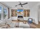Bright living room featuring a fireplace, built-in shelving, and comfortable seating arrangement at 112 Sire Ct, Holly Springs, NC 27540