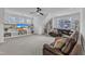 Spacious living room features a ceiling fan, built-in shelving, and a large leather sectional sofa at 112 Sire Ct, Holly Springs, NC 27540