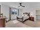 Cozy main bedroom with ceiling fan, side tables, and large window views at 112 Sire Ct, Holly Springs, NC 27540