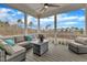 Inviting screened porch features cozy seating, a glass table, and serene views of the treelined landscape at 112 Sire Ct, Holly Springs, NC 27540