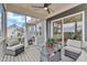 Comfortable screened porch with outdoor seating, glass table, ceiling fan and views of the backyard at 112 Sire Ct, Holly Springs, NC 27540
