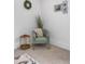 Bedroom sitting area with green chair, side table, and rug at 112 Sire Ct, Holly Springs, NC 27540