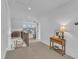 Upstairs landing featuring a hall table, carpet and view of the bonus room at 112 Sire Ct, Holly Springs, NC 27540