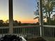 Relaxing screened porch has an expansive view of the sunset over a treelined backyard at 112 Sire Ct, Holly Springs, NC 27540