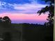 Beautiful scenery featuring an expansive view of the colorful sunset and treelined backyard at 112 Sire Ct, Holly Springs, NC 27540
