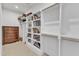 Spacious walk-in closet with custom shelving and hardwood rods for hanging storage at 112 Sire Ct, Holly Springs, NC 27540