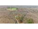 Aerial view of private wooded lot with a beautiful custom home at 1124 Westridge Rd, Rougemont, NC 27572
