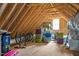 Spacious unfinished attic with wood beams and some boxes for storage at 1124 Westridge Rd, Rougemont, NC 27572