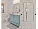 Bright bathroom featuring a vanity with blue cabinets, framed mirror, and glass shower, offering a clean and modern feel at 1124 Westridge Rd, Rougemont, NC 27572