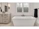 Modern bathroom featuring a freestanding tub, sleek fixtures, and a bright window view at 1124 Westridge Rd, Rougemont, NC 27572