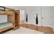 Bunk room with wooden bunkbed and ample storage, as well as access to the ensuite bathroom at 1124 Westridge Rd, Rougemont, NC 27572