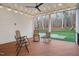 Relaxing covered deck with ceiling fan, string lights, and comfortable seating for outdoor enjoyment at 1124 Westridge Rd, Rougemont, NC 27572