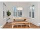 Bright dining room featuring a wooden table set, a unique light fixture and large windows at 1124 Westridge Rd, Rougemont, NC 27572