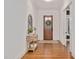 Inviting foyer featuring hardwood floors, a decorative table with flowers, and a wooden front door with wreath at 1124 Westridge Rd, Rougemont, NC 27572