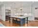 Modern kitchen with a large island, stainless steel appliances, and pendant lighting at 1124 Westridge Rd, Rougemont, NC 27572