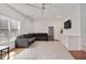 Open living room with a large sectional sofa, ceiling fan, hardwood floors, and natural light at 1124 Westridge Rd, Rougemont, NC 27572