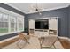 Cozy sitting room with custom built-ins, modern lighting, and backyard views at 1124 Westridge Rd, Rougemont, NC 27572