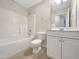 Bright bathroom featuring a shower-tub combination and white vanity with storage at 12 Stonegate Dr, Angier, NC 27501