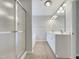 Bathroom featuring double sinks and a shower with glass doors at 12 Stonegate Dr, Angier, NC 27501