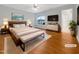 Staged main bedroom with a king-size bed, ceiling fan and ensuite bath at 12 Stonegate Dr, Angier, NC 27501