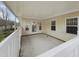 Covered patio with white railing, offering a relaxing outdoor space at 12 Stonegate Dr, Angier, NC 27501