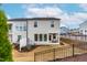 Townhouse exterior with a black fence, covered patio, and grassy backyard at 1201 Canary Pepper Dr, Durham, NC 27713