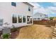 A view of the townhouse backyard featuring a covered patio and black fence at 1201 Canary Pepper Dr, Durham, NC 27713