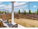 Backyard patio with seating area is enhanced with tiered landscaping and a black iron fence at 1201 Canary Pepper Dr, Durham, NC 27713