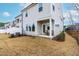 Townhome exterior boasts a covered patio and grassy area with fresh mulch at 1201 Canary Pepper Dr, Durham, NC 27713