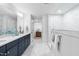 Bathroom featuring a double vanity, natural light, and a glass shower at 1201 Canary Pepper Dr, Durham, NC 27713